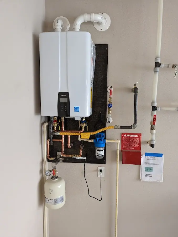 Professional plumber installing copper piping in a Wellfleet home